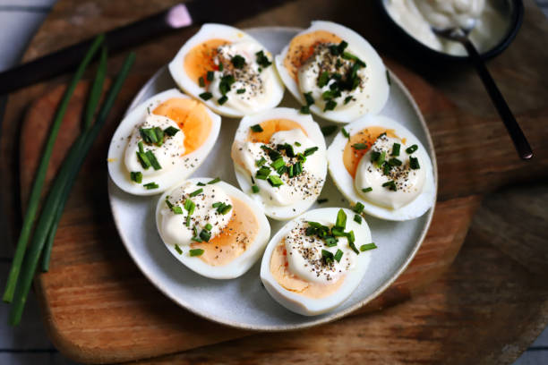 istock Boiled egg halves with mayonnaise and green onions. 1440926697