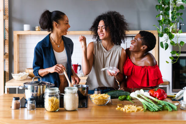 istock Three mixed race hispanic and black women bonding at home 1440927574