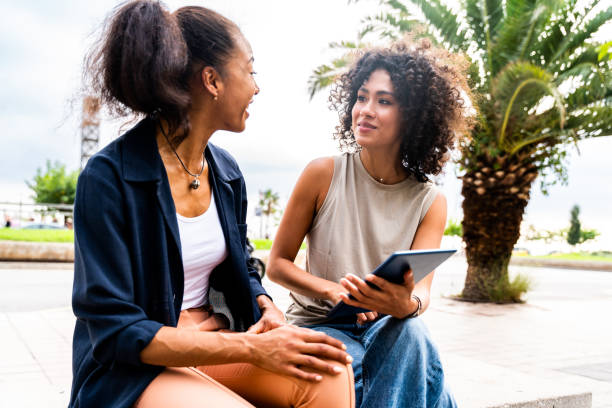 istock Two mixed race hispanic women bonding outdoors 1440932426