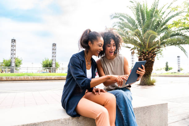 istock Two mixed race hispanic women bonding outdoors 1440932518