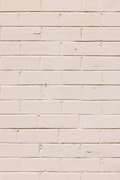 istock Part of a painted old beige brick wall 1440932646