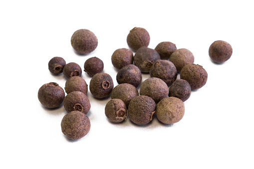 Jamaica pepper, traditional spices. allspice close-up. selective focus Spices, allspice. Isolated on white background macroshoot