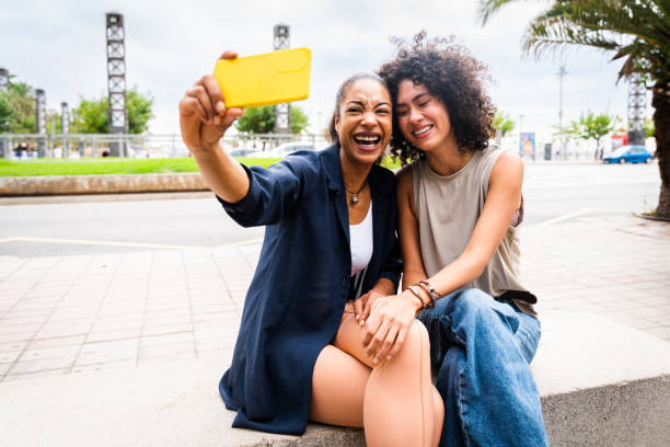 istock Two mixed race hispanic women bonding outdoors 1440932762