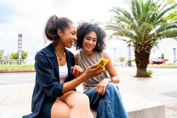 istock Two mixed race hispanic women bonding outdoors 1440932864