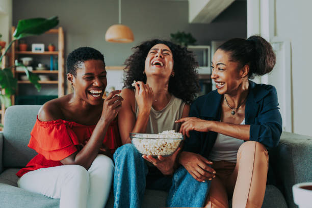 Three mixed race hispanic and black women bonding at home stock photo