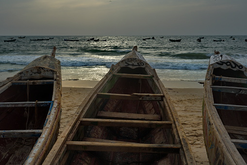 Nouakchott. Mauritania. October 04, 2021. Hundreds of huge painted wooden boats, on which local fishermen go to sea, are parked on the shore of the Atlantic Ocean. Each boat is painted individually.