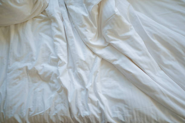 istock messy bed in early morning , messy bed after waking up 1440933977