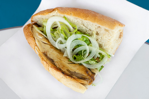 A traditional Istanbul fast food served with bonito, fried onions, lettuce and bread.