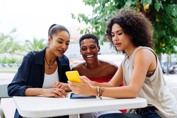 istock Three mixed race hispanic and black women bonding outdoors 1440934069