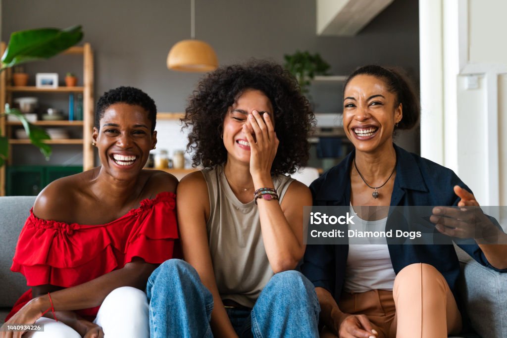 Three mixed race hispanic and black women bonding at home Happy beautiful hispanic south american and black women meeting indoors and having fun - Black adult females best friends spending time together, concepts about domestic life, leisure, friendship and togetherness Black People Stock Photo