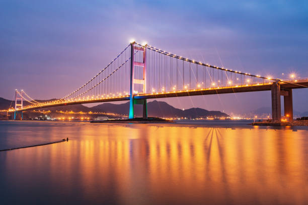 istock Suspension bridge to Park island at evening time. 1440934253