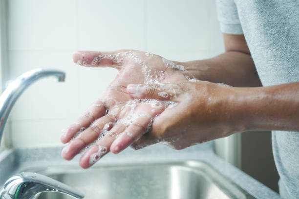 istock young man washing hands with soap warm water 1440934925