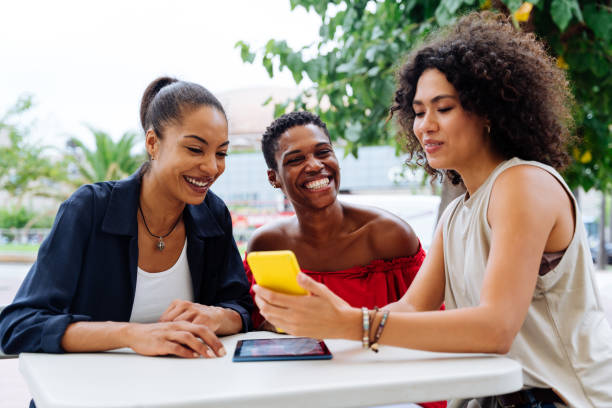 istock Three mixed race hispanic and black women bonding outdoors 1440934944