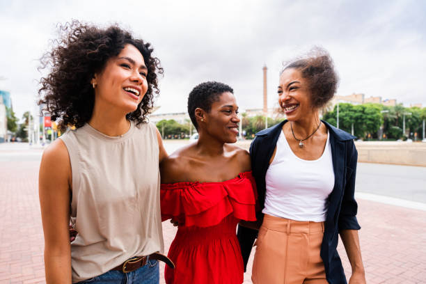 istock Three mixed race hispanic and black women bonding outdoors 1440935065