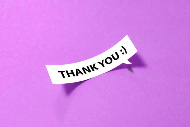 istock Thank you message on curled speech bubble on purple background 1440935524