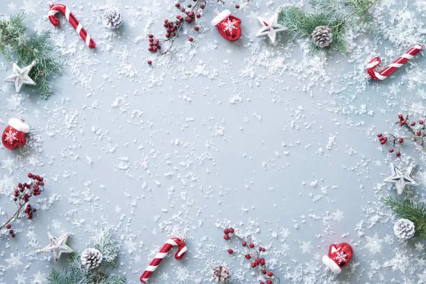 Winter fir branches, berries and decorations on snowy background. Christmas and New year concept. Top view