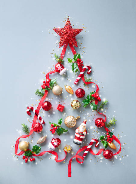 istock Christmas background made from fir tree branches, red ribbon, holly berries, decorations and lights 1440939003