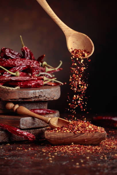 istock Chilli flakes are poured into a wooden dish. 1440939783