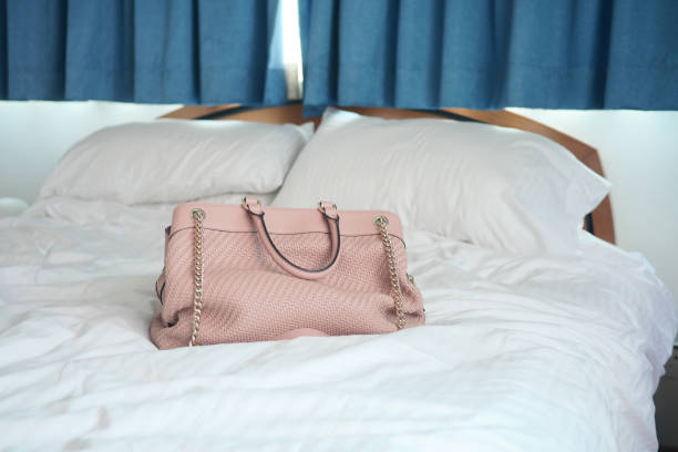 istock women purse wallet on bed, close up. 1440941894