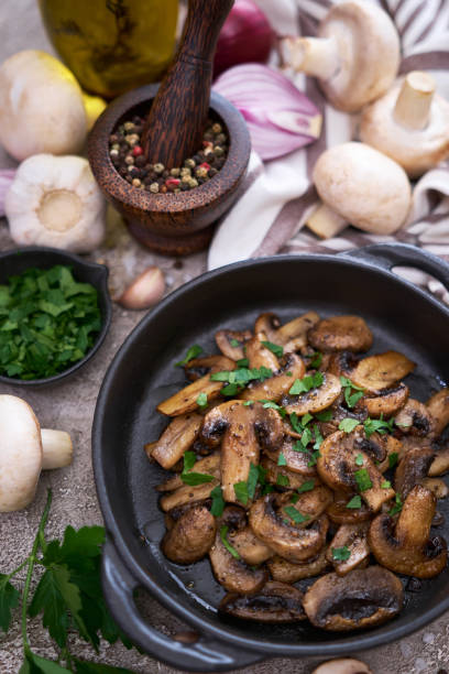 istock black ceramic bowl with fried mushrooms on grey concrete background 1440945172