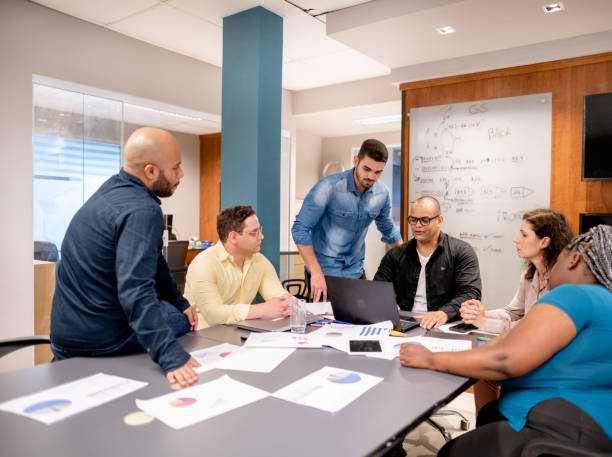 istock Businessman using laptop discussing new plan with team in office meeting 1440946737