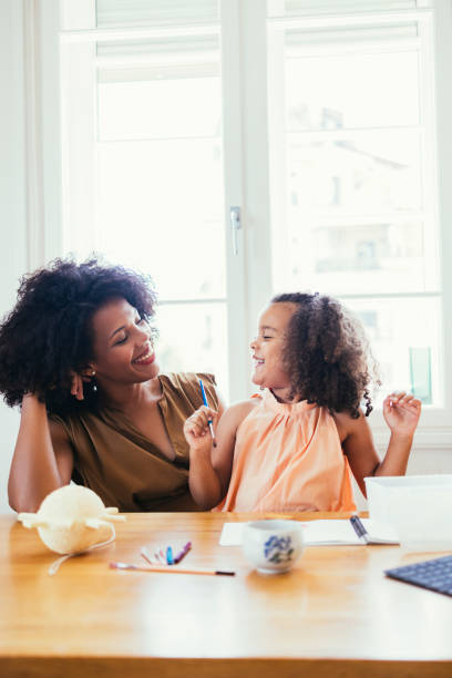 istock Mother And Her Daughter Drawing Together 1440949704