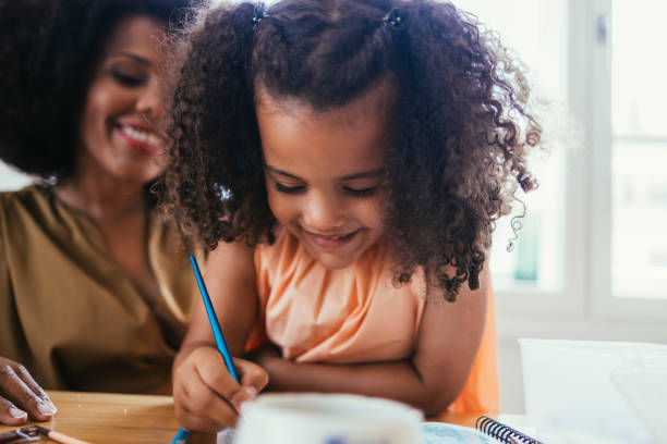 istock Mother And Her Daughter Drawing Together 1440949711