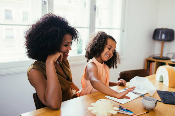 istock Mother And Her Daughter Drawing Together 1440949737
