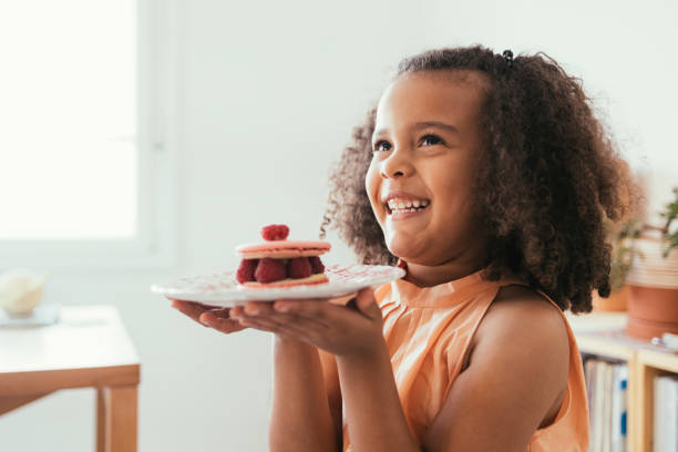 istock Girl Holding A Plate With A Cake On It 1440949775