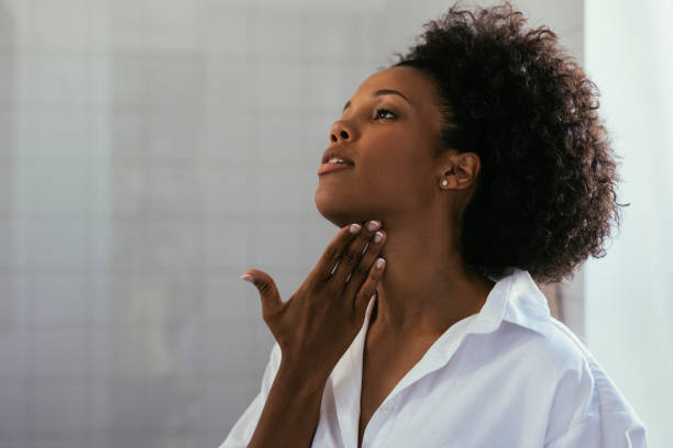 istock Woman Applying Creme On Her Skin 1440949804