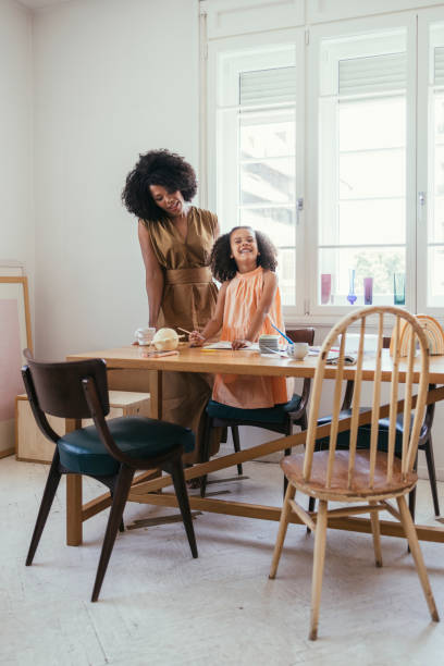 istock Tutor Helping Little Girl With Homework 1440949838