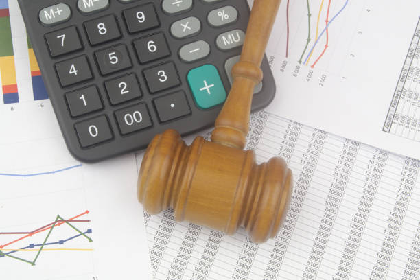istock Arbitration concept, wooden judge gavel and calculator on financial documents. 1440953410