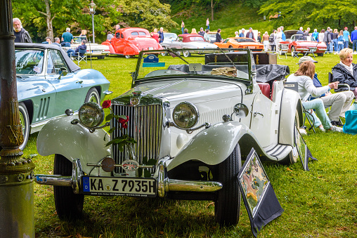 Baden-Baden, Germany - 14 July 2019: white beige Morris MG T-Tupe TA TB TC Midget cabrio roadster 1936 1955 is parked in Kurpark in Baden-Baden at the exhibition of old cars 