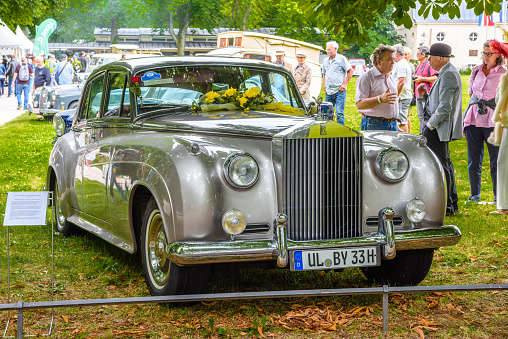 Baden-Baden, Germany - 14 July 2019: silver gray metalic Rolls-Royce Silver Cloud 1 2 I II sedan limousine 1955 1962 is parked in Kurpark in Baden-Baden at the exhibition of old cars \