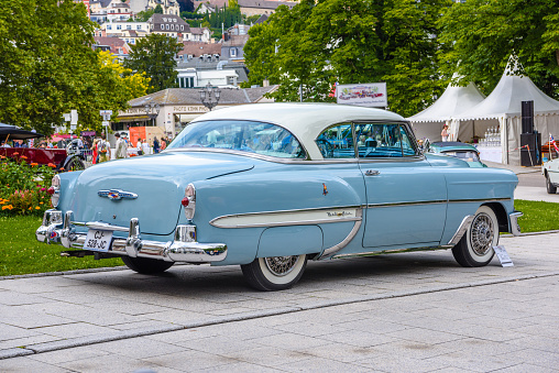 Baden-Baden, Germany - 14 July 2019: blue white Chevrolete Belair sport coupe 1953 is parked in Kurpark in Baden-Baden at the exhibition of old cars 