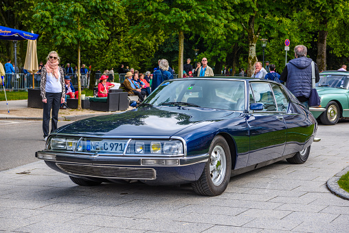Baden-Baden, Germany - 14 July 2019: dark blue Citroen SM coupe 1970 1975 with opened hood is parked in Kurpark in Baden-Baden at the exhibition of old cars \