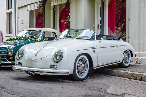 Baden-Baden, Germany - 14 July 2019: white Porsche 356 Speedster sport car cabrio roadster 1957 1948 1965 is parked in Kurpark in Baden-Baden at the exhibition of old cars 