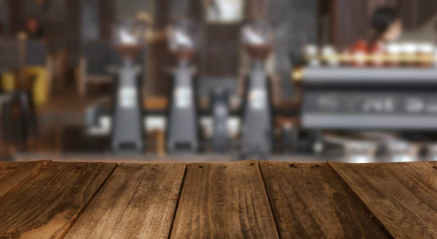 istock empty wooden table with Blur coffee shop or cafe restaurant with abstract bokeh light image background. 1440953604