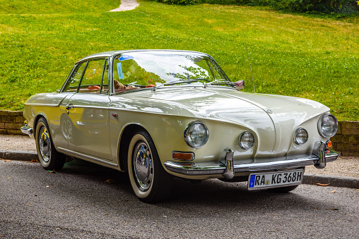 Baden-Baden, Germany - 14 July 2019: white ivory beige VW Volkswagen Karmann-Ghia Type 34 coupe 1961 1974 is parked in Kurpark in Baden-Baden at the exhibition of old cars \
