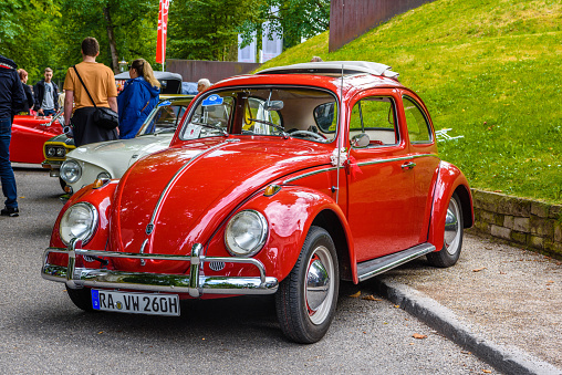 Baden-Baden, Germany - 14 July 2019: red VW Volkswagen Beetle Type 1 is parked in Kurpark in Baden-Baden at the exhibition of old cars \