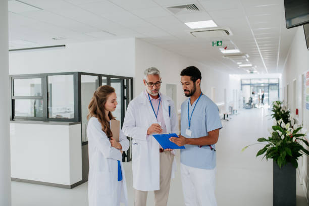 istock Doctors discussing something at hospital corridor. 1440954682