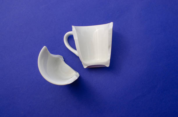 istock Broken cup, broken glass parts, crockery halves or broken white cup, disintegration or accident and cuts (danger and caution) concept. 1440955113