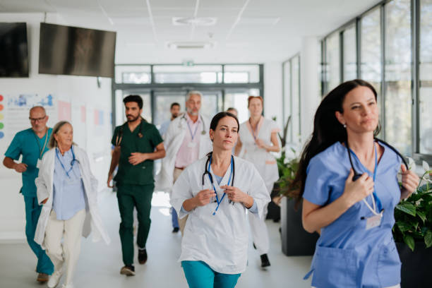 istock Young stressed doctors running at hospital corridor. 1440955225