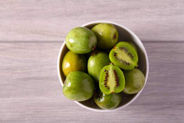 Mini kiwi fruits Mini kiwi fruits in a bowl mini kiwi stock pictures, royalty-free photos & images