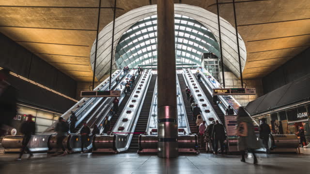 Time lapse of Crowded Commuter business office people using escalator for traveling to work at Canary Wharf