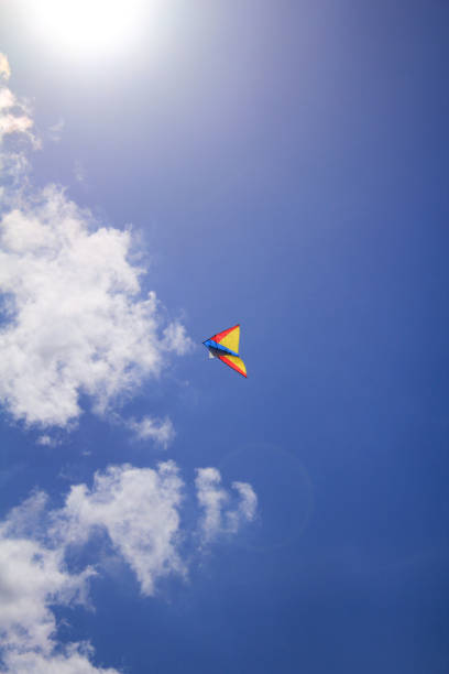 istock A flying kite in the clear blue sky with clouds 1440961427