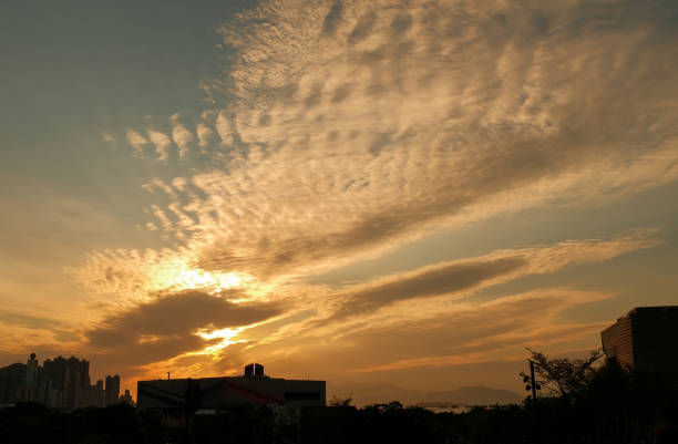 istock Cloudscape with beautiful clouds at sunset with city shadow 1440961532