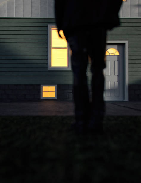 istock Lone man in suit stands by an illuminated house at dusk. Rear view. 3D render. 1440961618