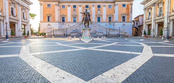 ROME, ITALY - CIRCA AUGUST 2020: Capitolium Square (Piazza del Campidoglio). Made by Michelangelo, it is home of Rome (Roma) City Hall. Sunrise light, before turist arrival.