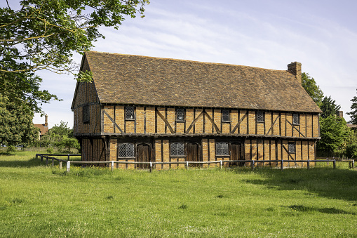 Bedford, United Kingdom – June 14, 2021: The 15th century timbre framed Moot Hall in the village of Elstow, Bedfordshire. This was the birthplace of John Bunyan.